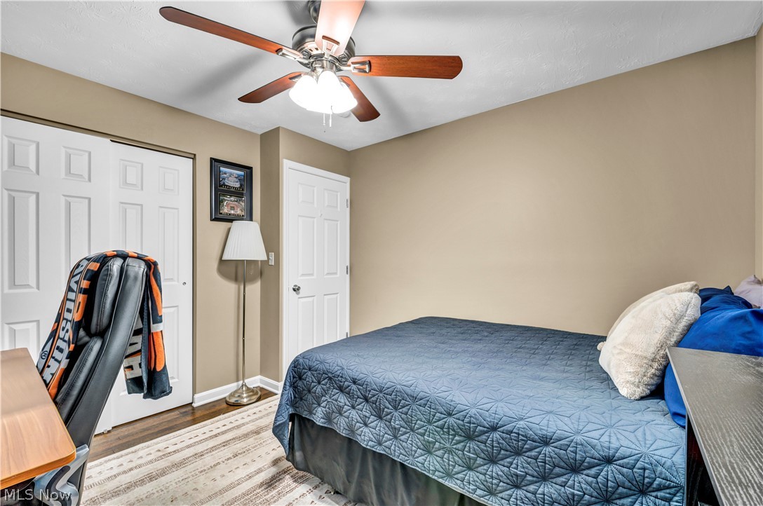 977 Lloyd Road Wickliffe, OH 44092 - Photo 17 of 38 Ceiling fan with light fixture, wood-finish flooring, two-panel closet doors, and neutral wall color