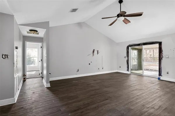 a view of empty room with wooden floor