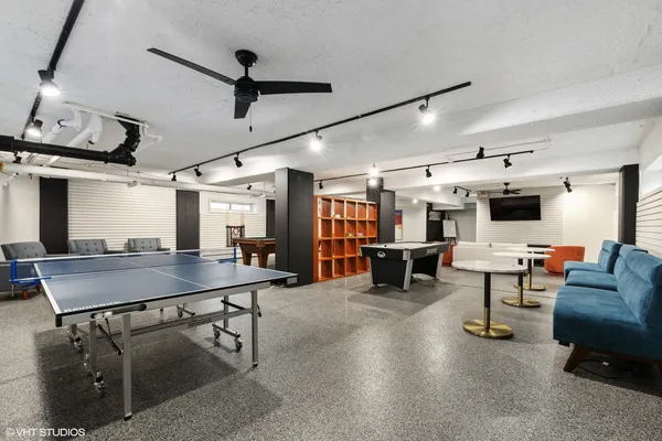 a room with furniture and a ceiling fan