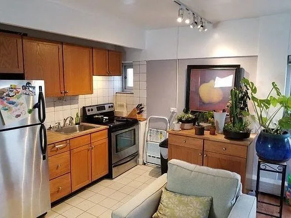 a kitchen with a refrigerator and a stove