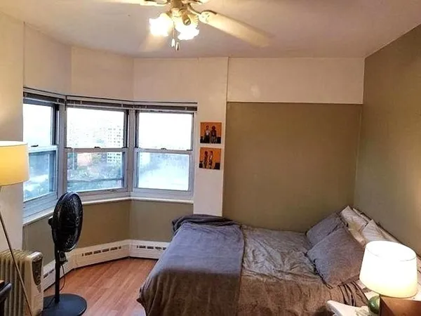 a bedroom with a bed and a window