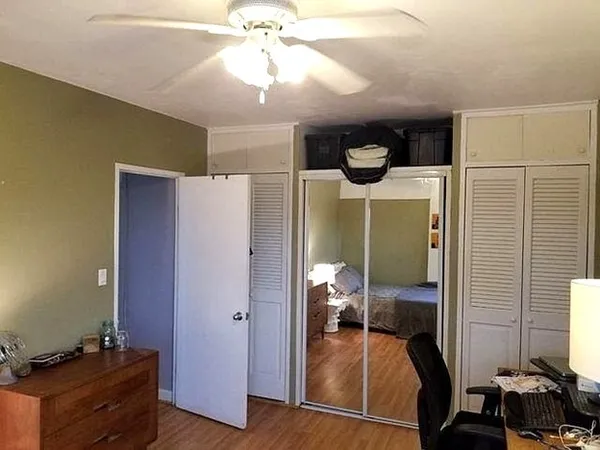 a bedroom with furniture and a mirror