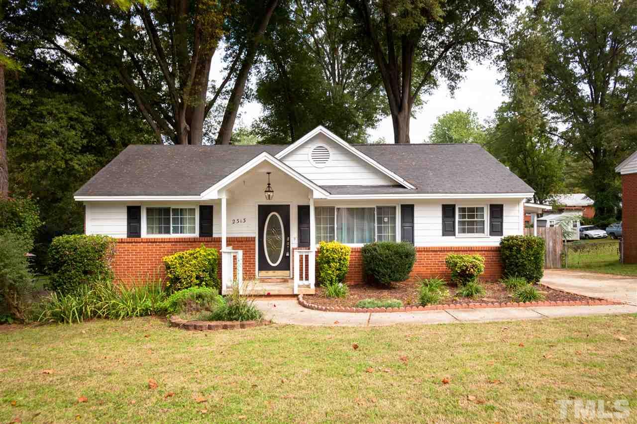 2313 Sheffield Road Raleigh, NC 27610 - Photo 1 of 25 a front view of a house with a porch and a yard