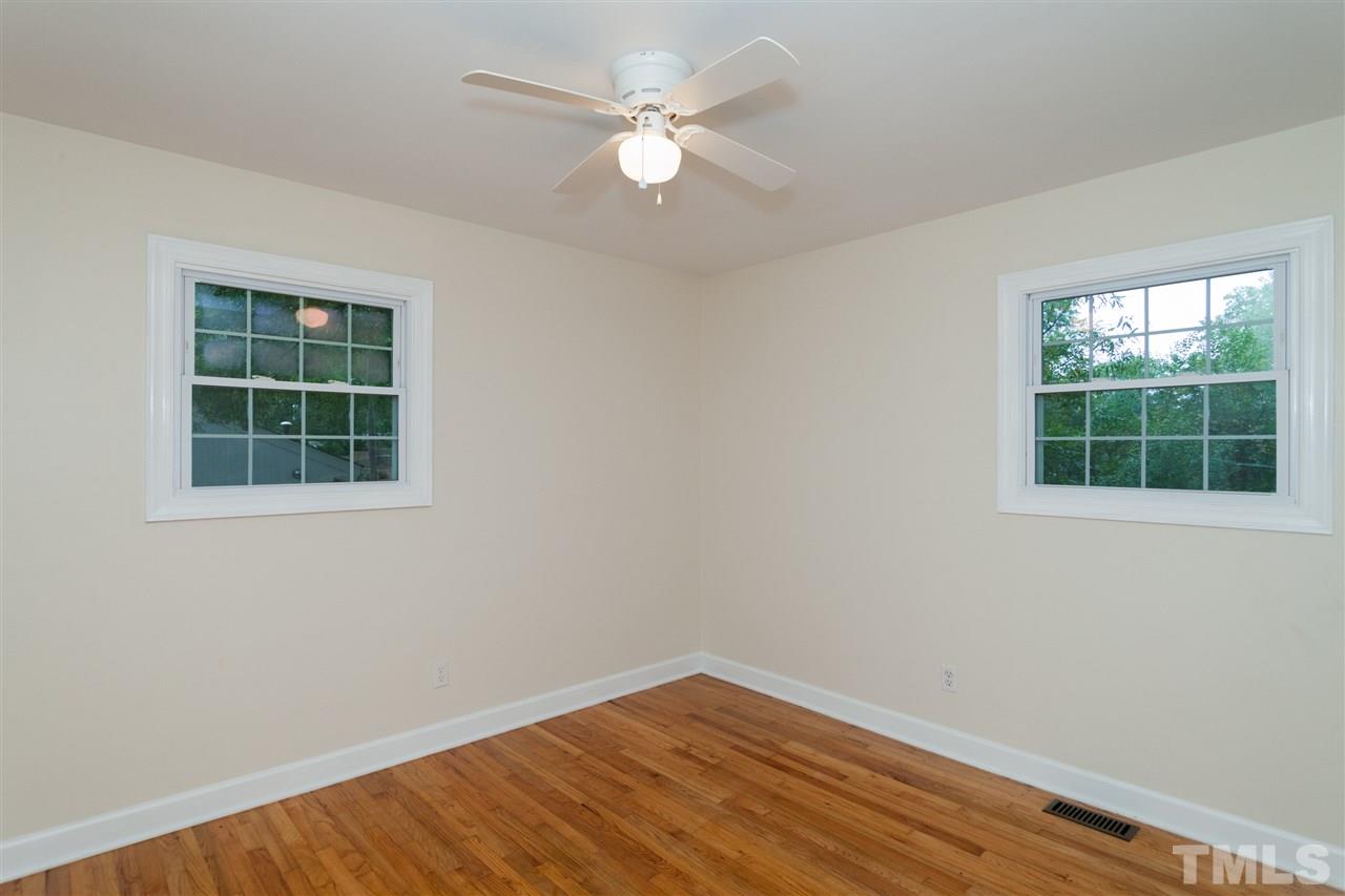 2313 Sheffield Road Raleigh, NC 27610 - Photo 11 of 25 an empty room with a window and a ceiling fan