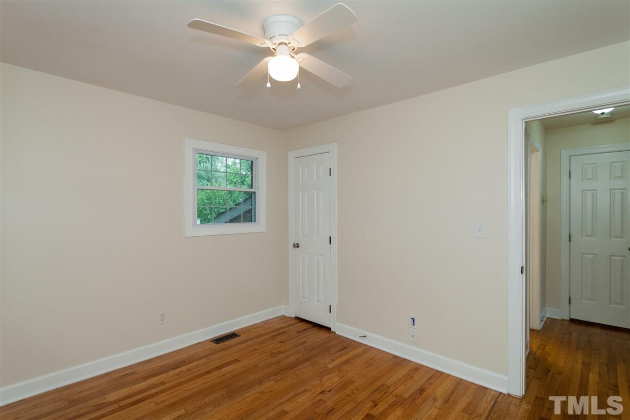 2313 Sheffield Road Raleigh, NC 27610 - Photo 12 of 25 an empty room with wooden floor and window