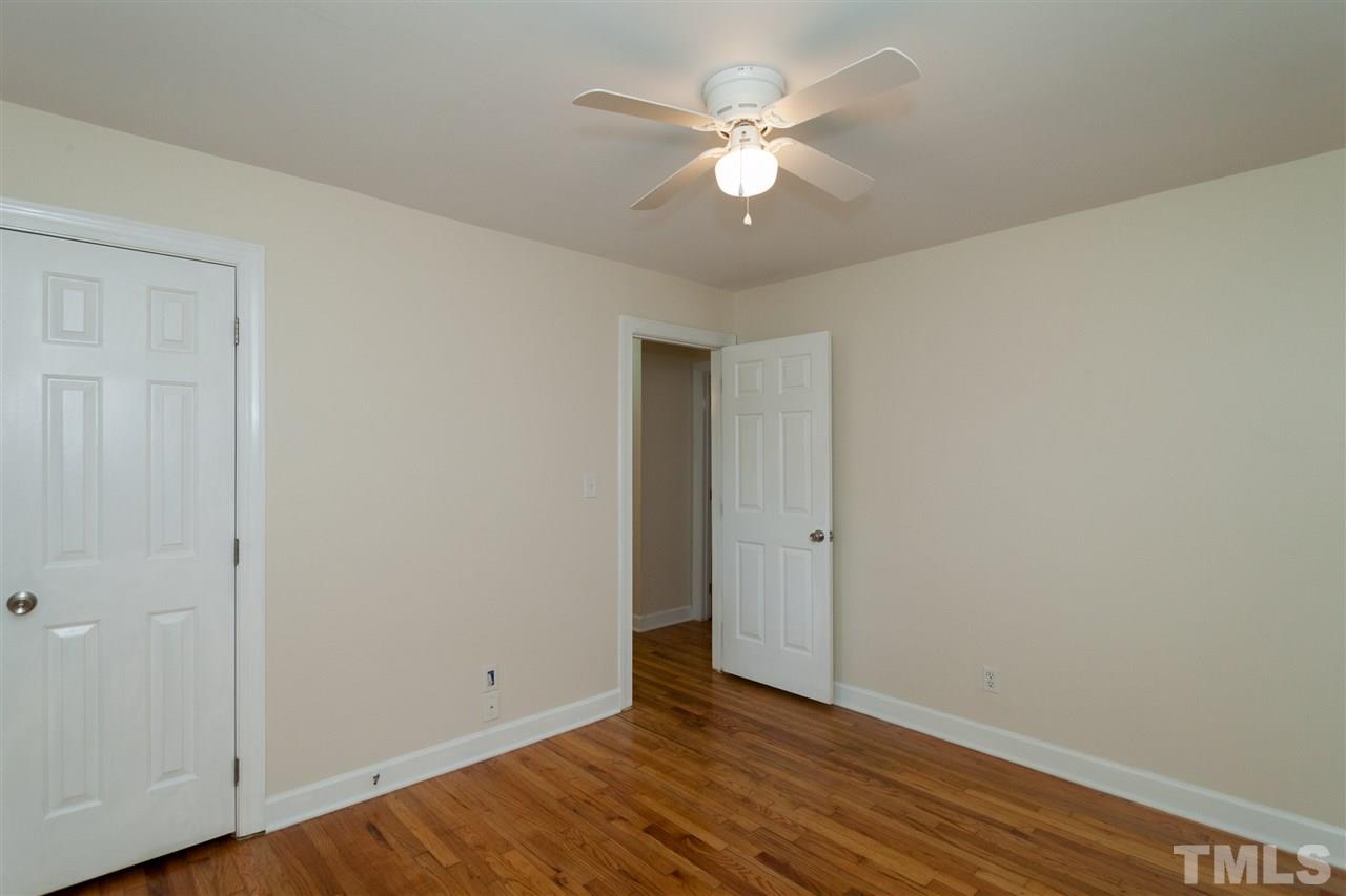 2313 Sheffield Road Raleigh, NC 27610 - Photo 13 of 25 a view of an empty room with wooden floor