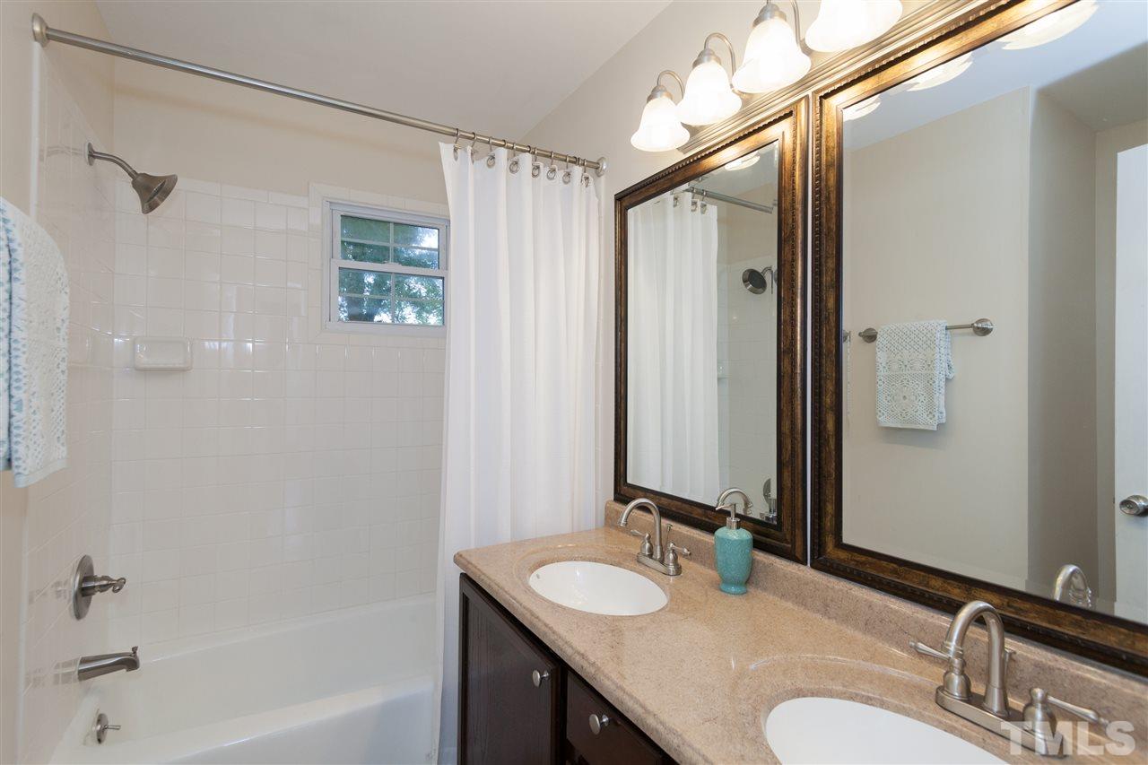 2313 Sheffield Road Raleigh, NC 27610 - Photo 14 of 25 a bathroom with a sink and a mirror