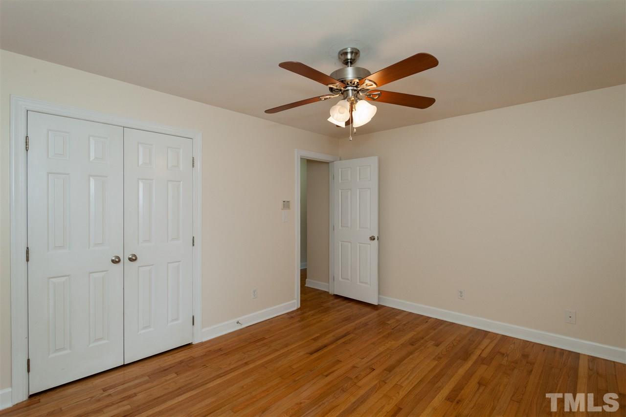 2313 Sheffield Road Raleigh, NC 27610 - Photo 17 of 25 a view of a room with wooden floor and white walls