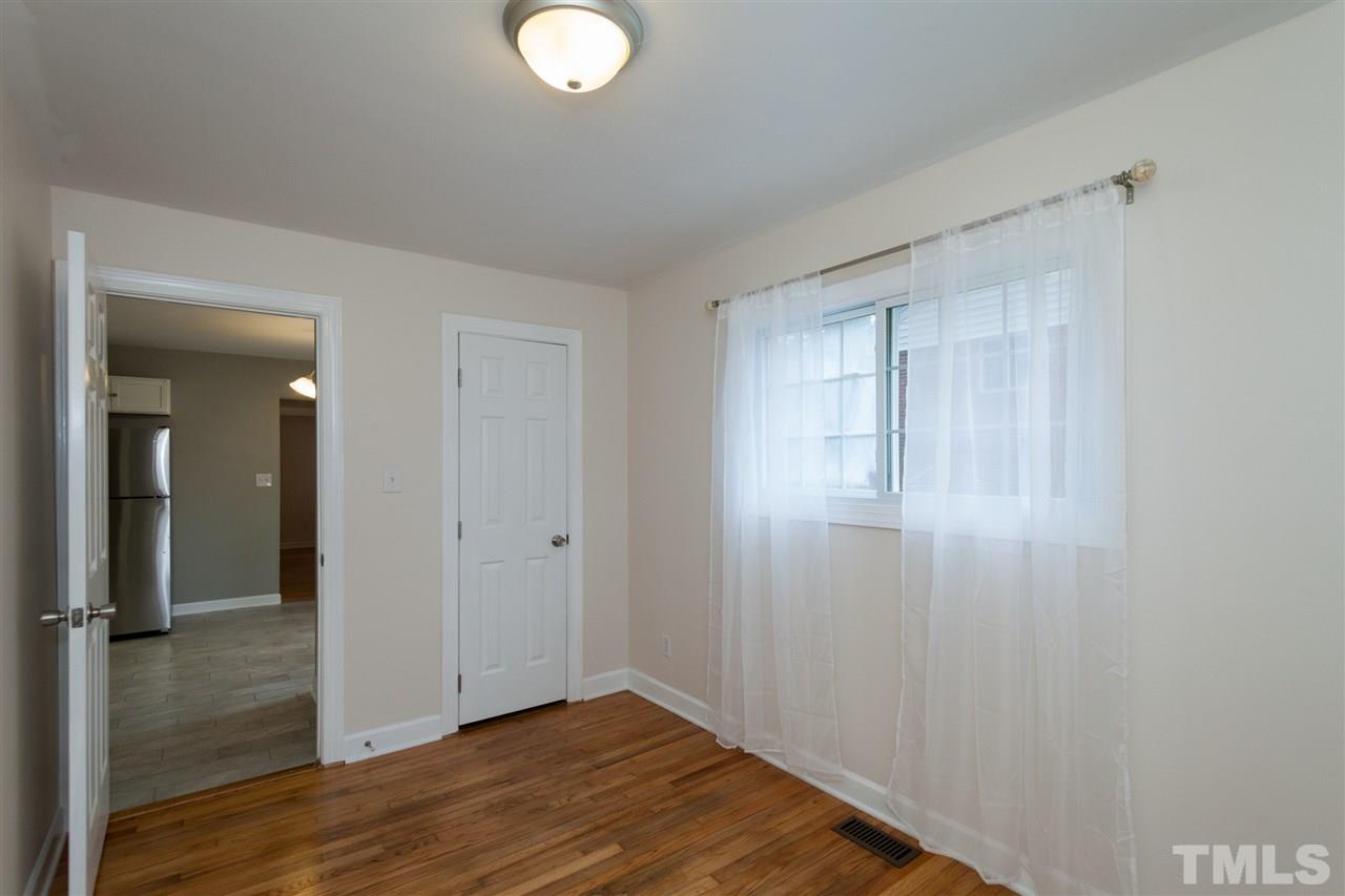 2313 Sheffield Road Raleigh, NC 27610 - Photo 19 of 25 a view of a livingroom with wooden floor