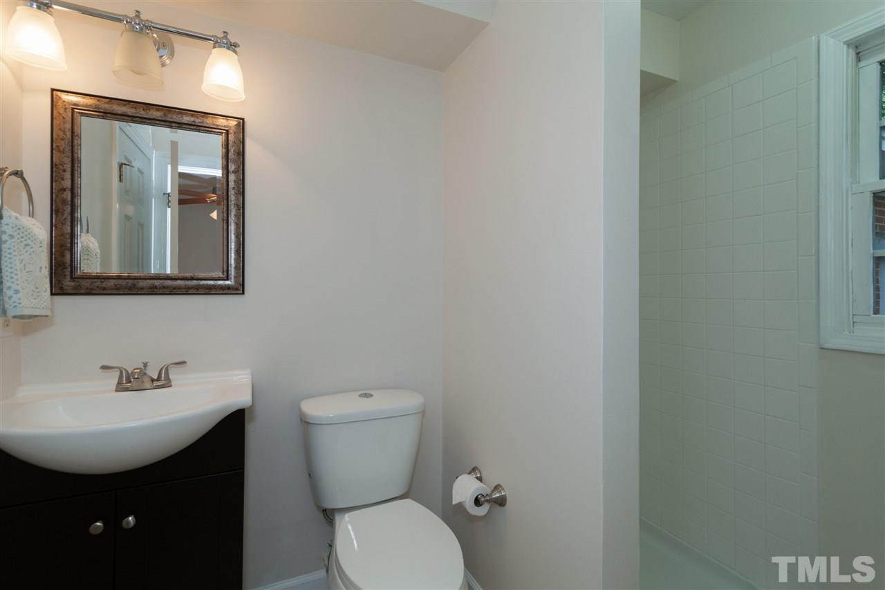 2313 Sheffield Road Raleigh, NC 27610 - Photo 21 of 25 a bathroom with a toilet a sink and mirror