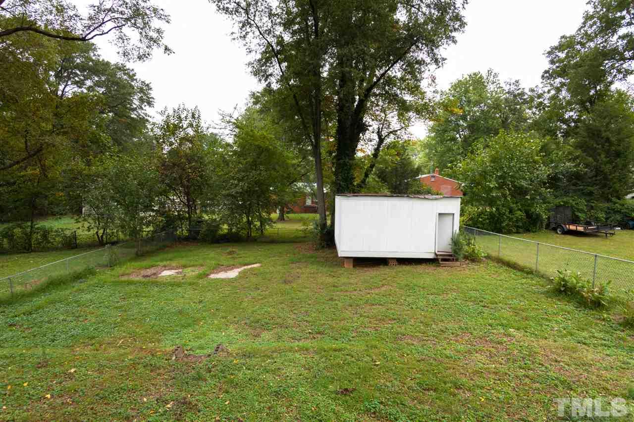 2313 Sheffield Road Raleigh, NC 27610 - Photo 24 of 25 a backyard of a house with lots of green space