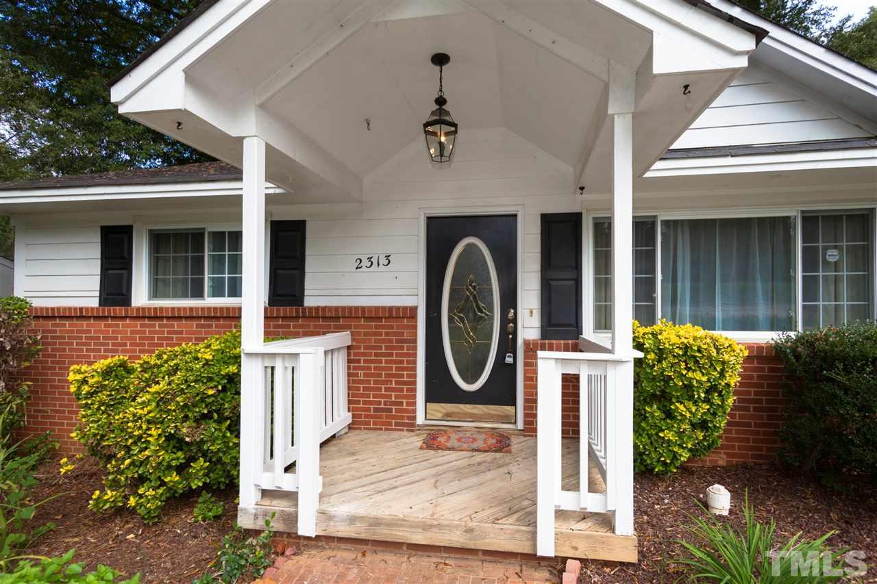 2313 Sheffield Road Raleigh, NC 27610 - Photo 4 of 25 a front view of a house with garden