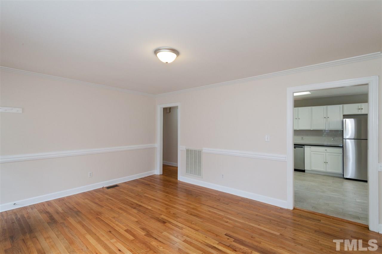 2313 Sheffield Road Raleigh, NC 27610 - Photo 8 of 25 wooden floor in an empty room with a window