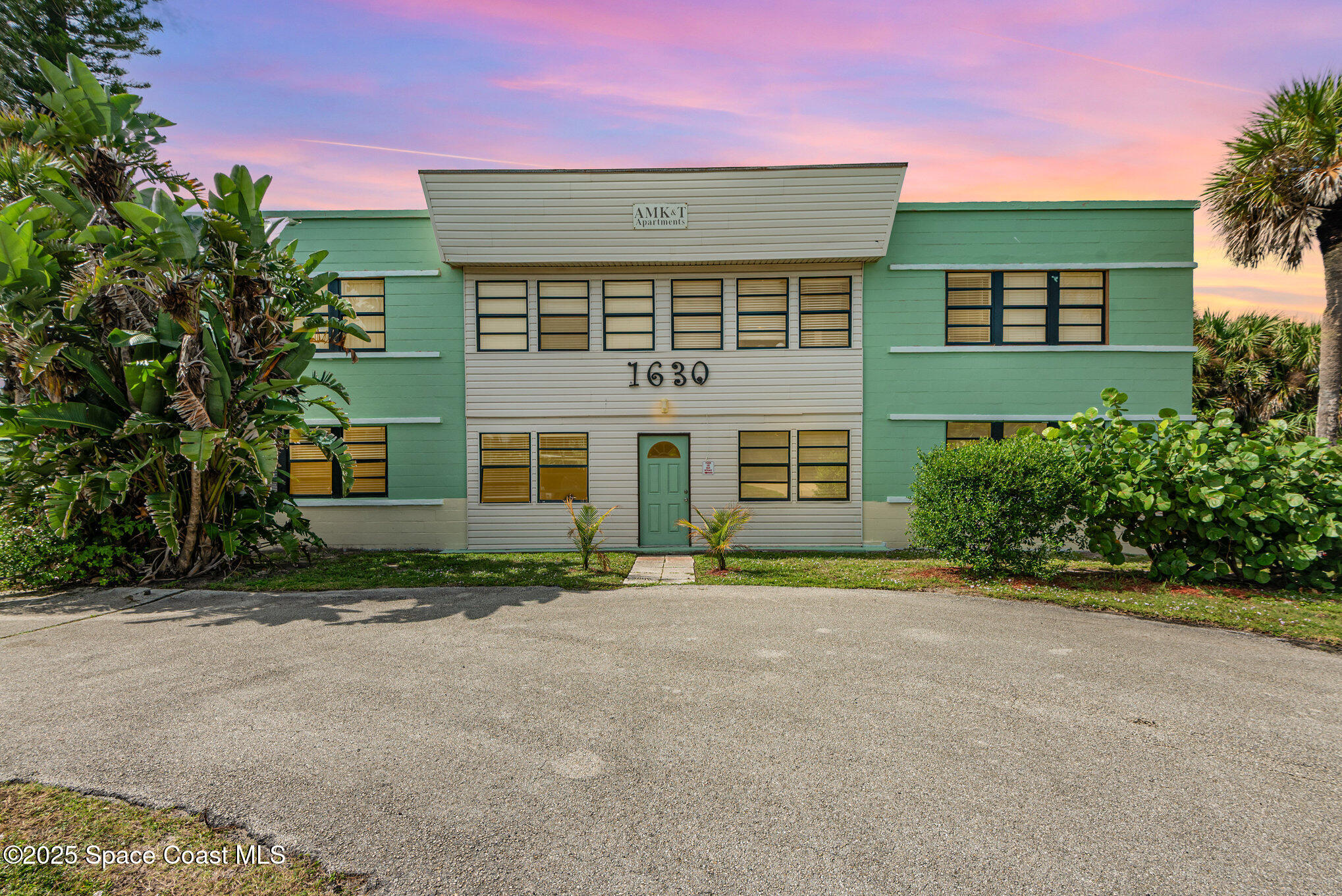 Undisclosed Address Cocoa Beach, FL 32931 - Photo 12 of 20 front view of a brick house with a yard