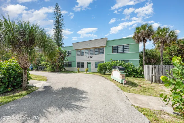 a view of a house with palm trees