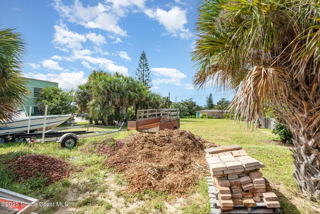 a view of a swimming pool with a yard and sitting area