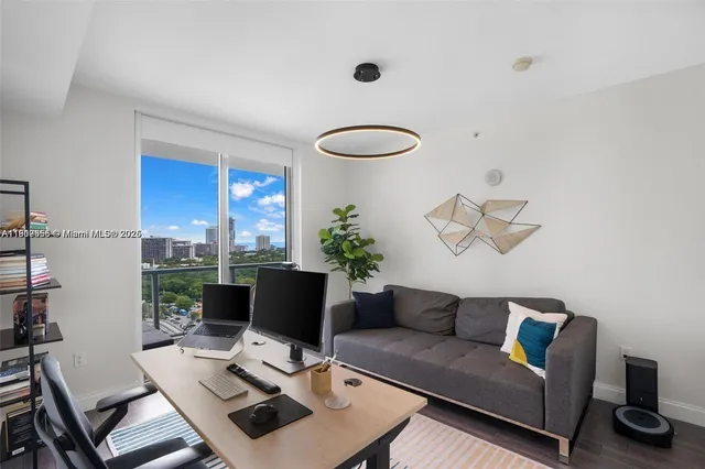 a living room with furniture and a laptop