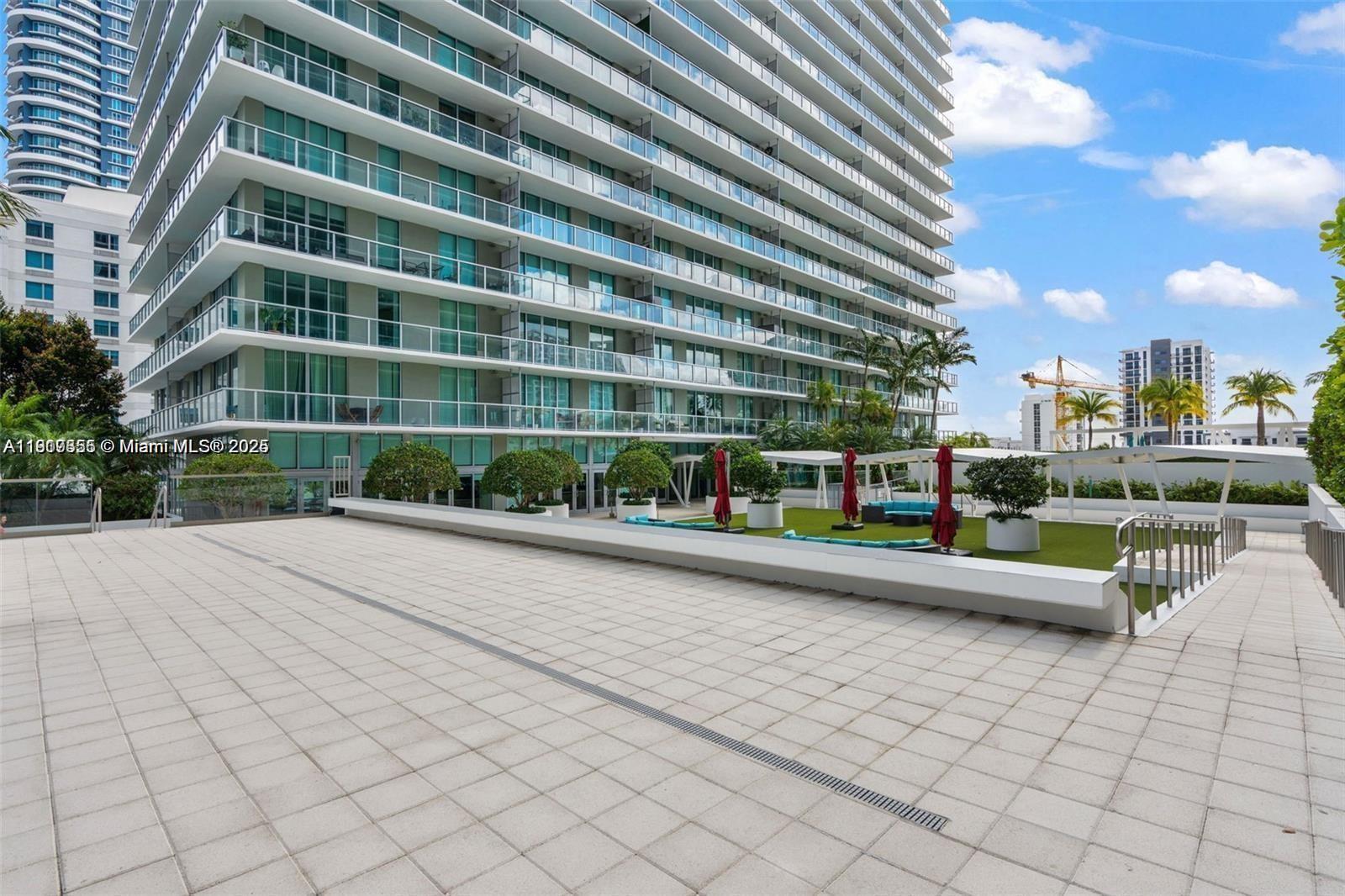 79 Southwest 12th Street, Unit 2204S Miami, FL 33130 - Photo 26 of 27 a view of pool with outdoor seating and plants