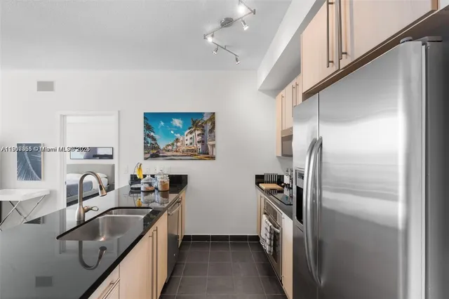 a kitchen with refrigerator cabinets and a sink