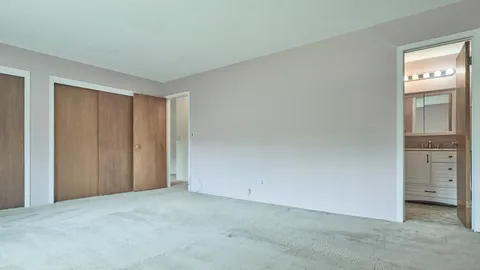 a view of an empty room and closet area