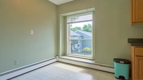 a view of room with window and hallway