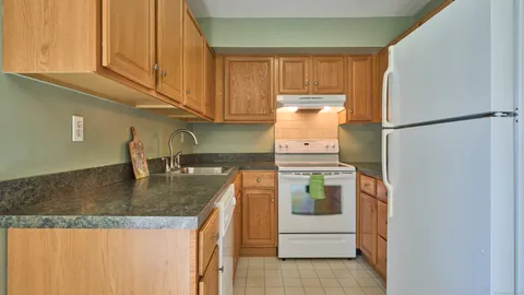 a kitchen with a sink a stove and cabinets