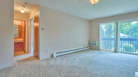 an empty room with windows and entrance