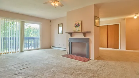 a view of an empty room with window and cabinet