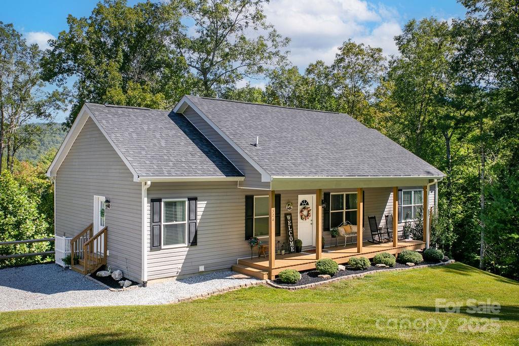 a view of a house with backyard porch and sitting area
