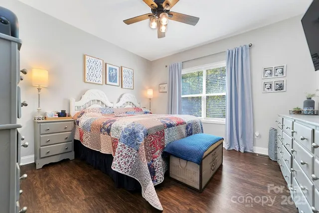 a spacious bedroom with a bed and a chandelier