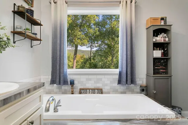 a bath tub sitting next to a window