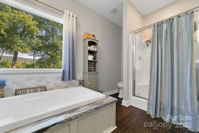 a bathroom with a bathtub sink and a window