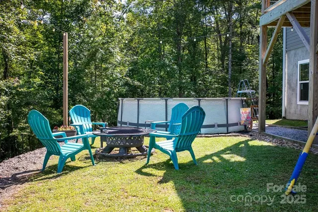 a view of a backyard with table and chairs