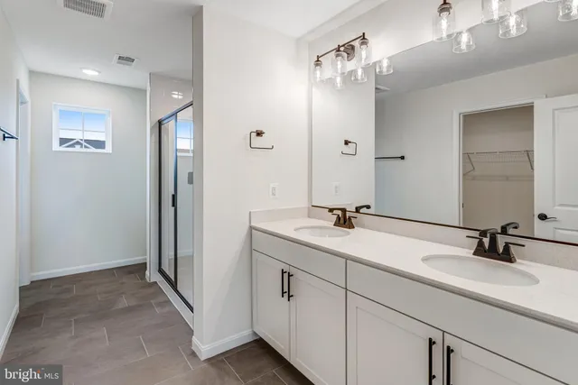 a bathroom with a glass shower door