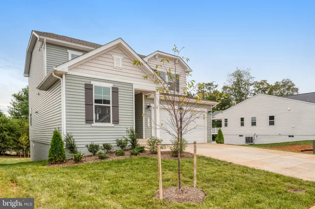 a view of a white house with a yard