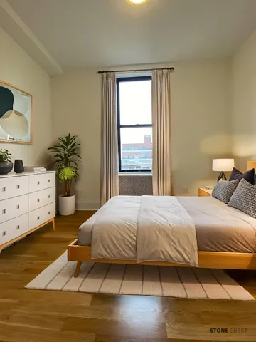 a bedroom with a bed and a dresser