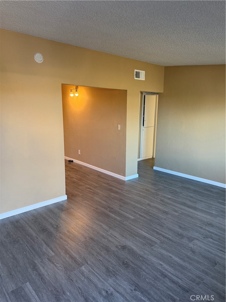 6030 Ocotillo Avenue Twentynine Palms, CA 92277 - Photo 4 of 10 a view of an empty room with wooden floor