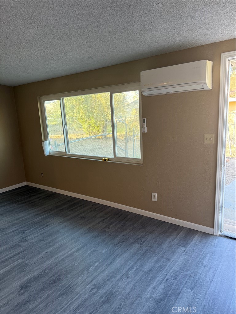6030 Ocotillo Avenue Twentynine Palms, CA 92277 - Photo 5 of 10 an empty room with wooden floor and windows