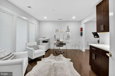 a bedroom with a bed a table and chair