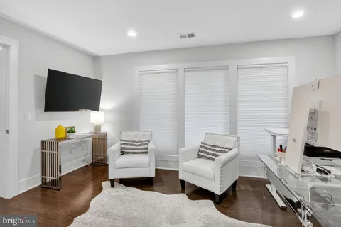a bathroom with a granite countertop toilet sink and a mirror