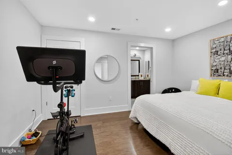 a large kitchen with a large counter top a sink stainless steel appliances and cabinets