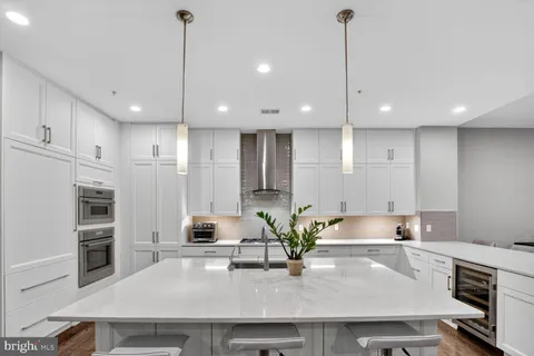 a kitchen with a table chairs sink and cabinets