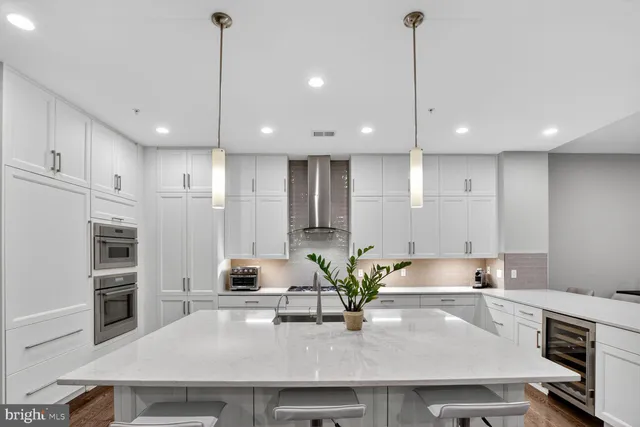 a kitchen with a table chairs sink and cabinets