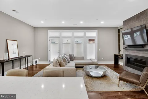 a dining room with furniture and wooden floor