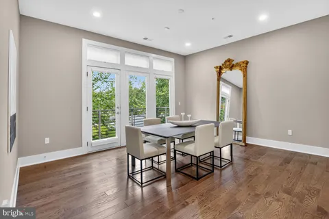 a spacious bedroom with a bed and glass door