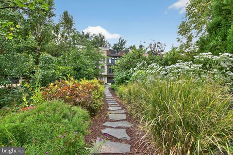 a view of backyard with table and chairs and plants
