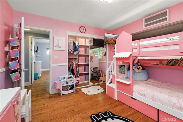 a bedroom with furniture and a wooden floor