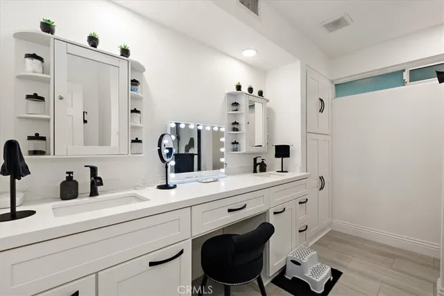 a bathroom with a sink double vanity and a mirror