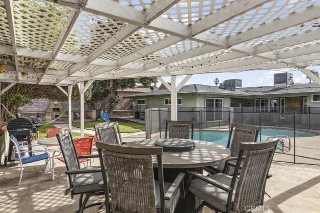 a view of a patio with a table and chairs