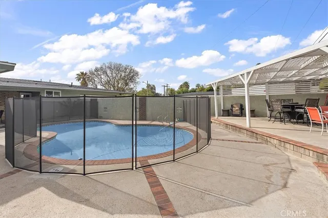 a view of a house with swimming pool and sitting area